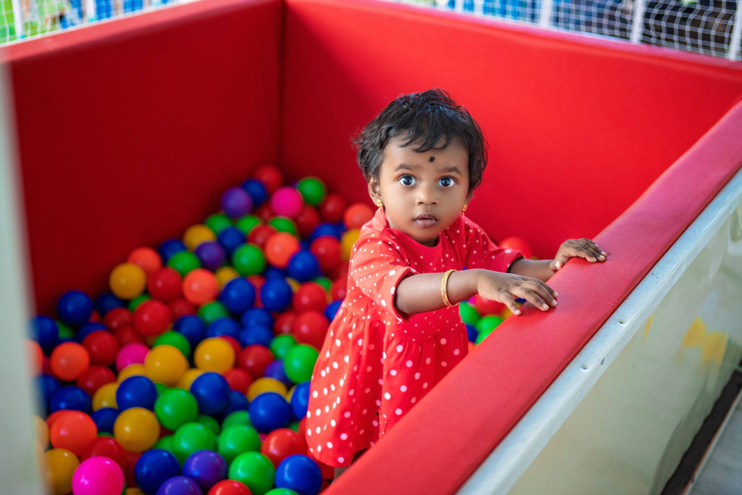 girl child in ball pool